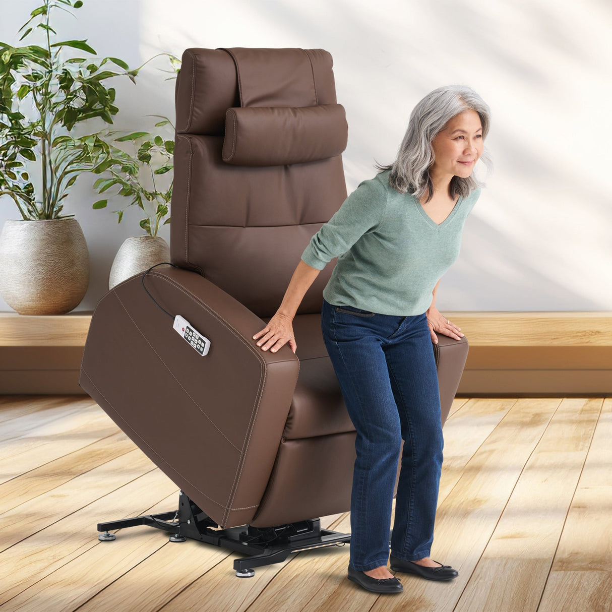 Laevo ZG Chair with Lift Assist shown in brown leather, demonstrating power lift feature in bright modern room setting