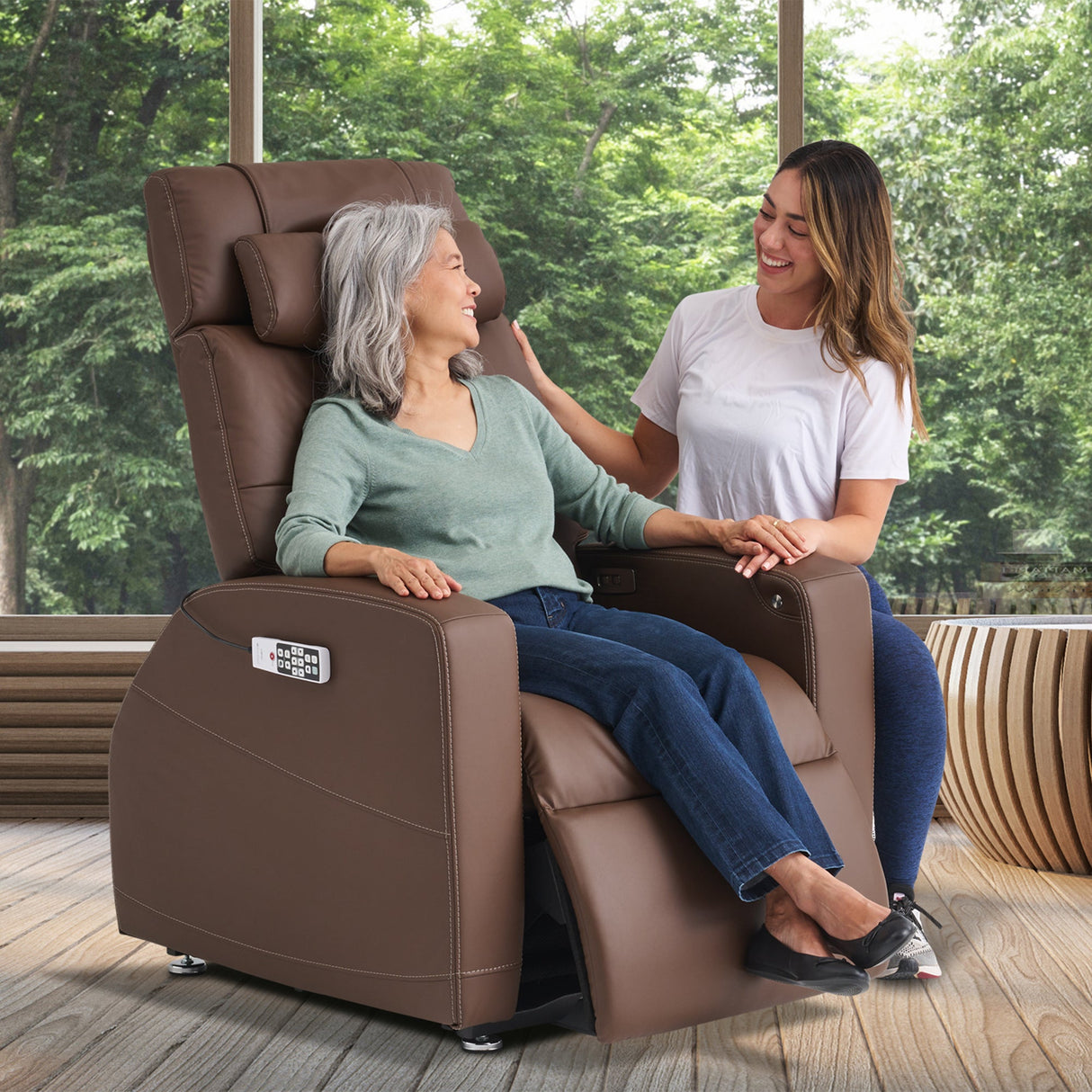 Laevo ZG Chair with Lift Assist shown in brown leather with caregiver demonstrating comfort features near sunlit windows