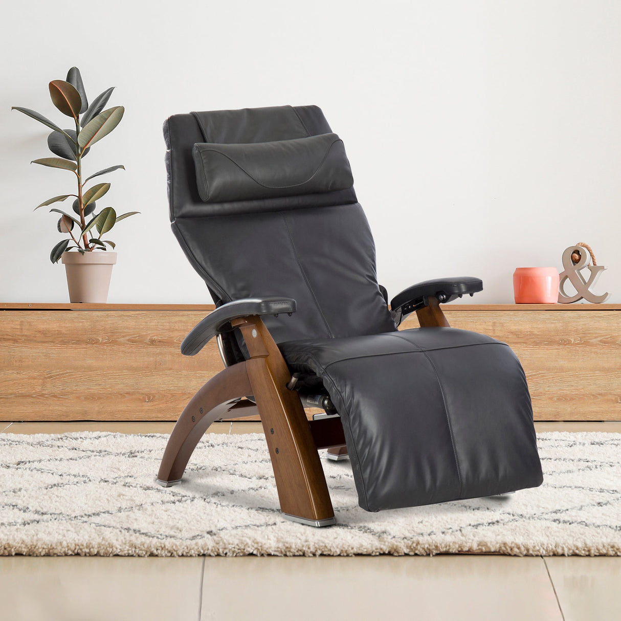 Perfect Chair PC-610 Omni-Motion Classic recliner in black leather with wooden base shown in relaxed position on light carpet