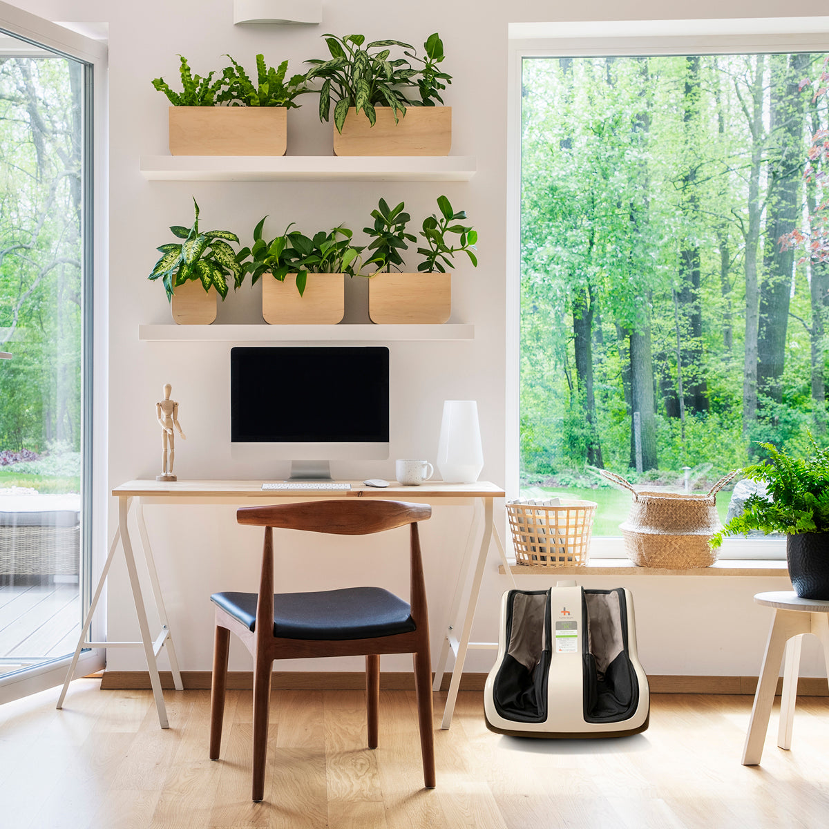 Reflex SOL Foot and Calf Massager shown in modern home office with wooden desk, plants, and large windows overlooking forest