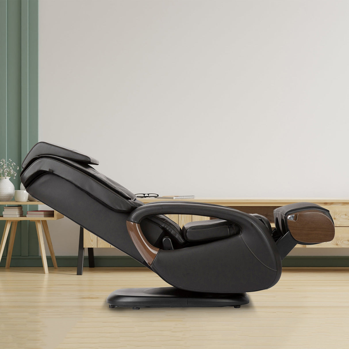 WholeBody 8.0 Massage Chair reclined in black leather with wood accents, shown in modern minimalist living room setting