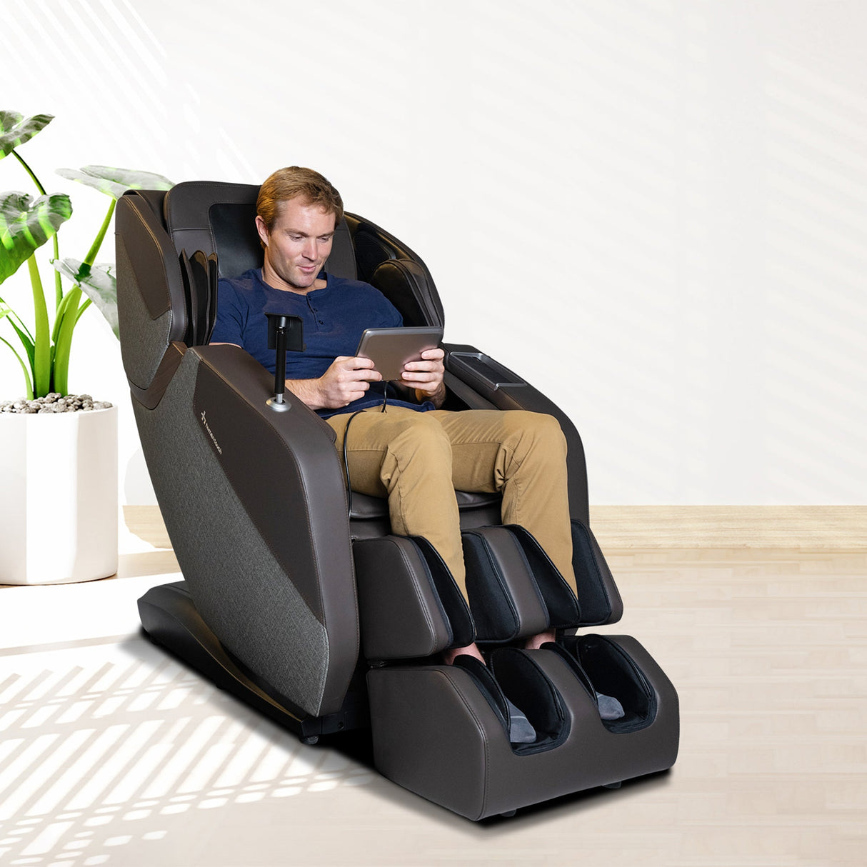 Man relaxing in WholeBody® ROVE Massage Chair with L-track for full body stretch and muscle recovery.