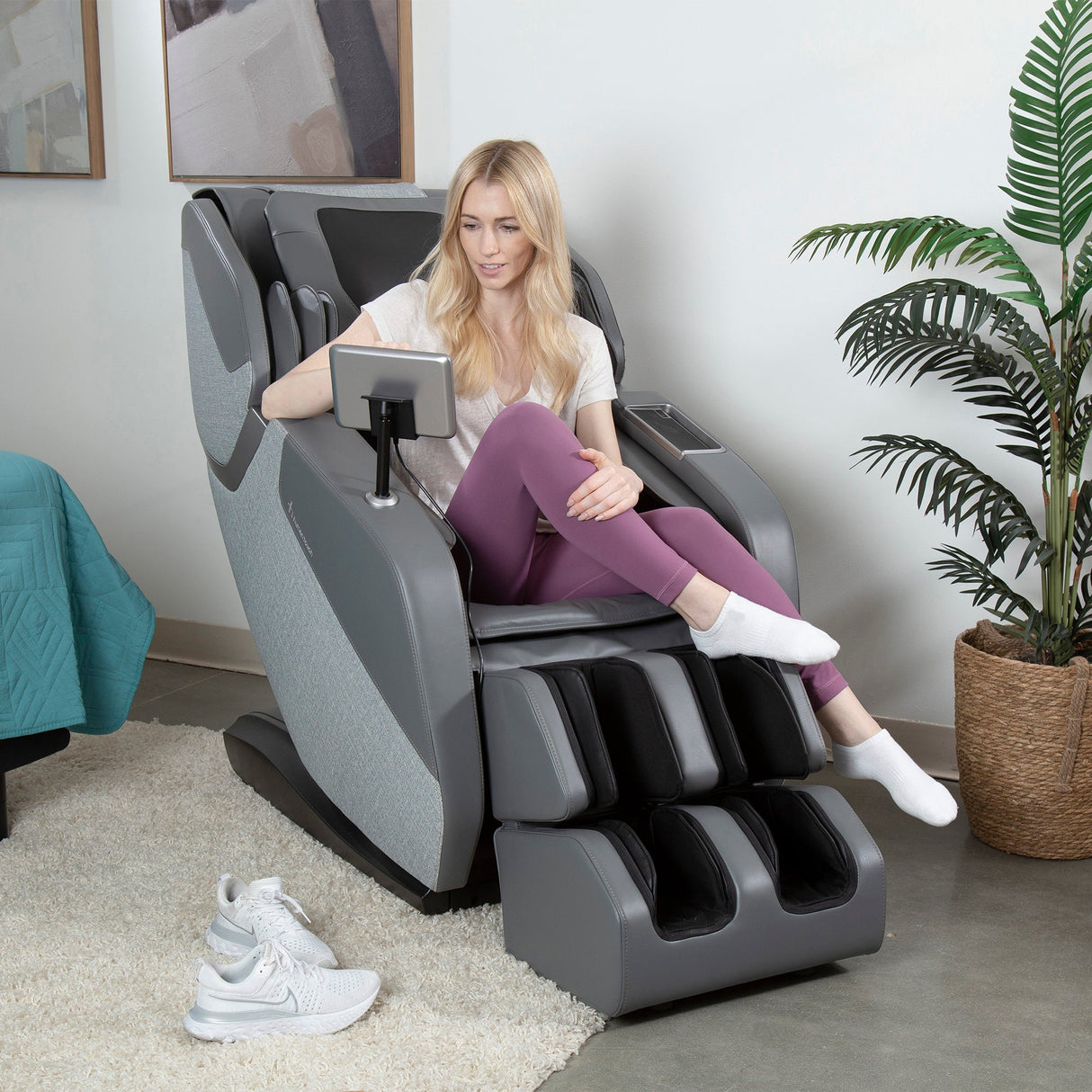 Woman relaxing in the WholeBody® ROVE Massage Chair with extended L-track for full body recovery and stretch.