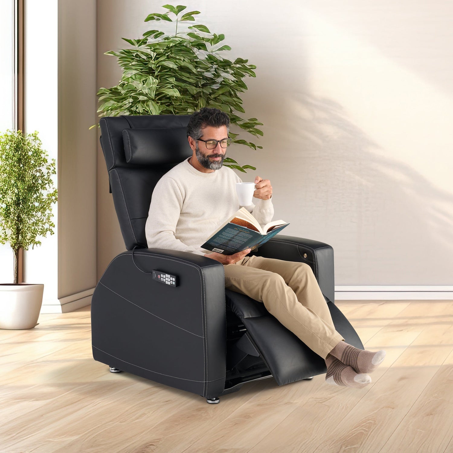 Laevo ZG Chair with Lift Assist shown in black leather, featuring person reading book in comfortable reclined position
