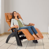 Perfect Chair PC-420 Classic Manual Plus recliner in tan leather, shown reclined with woman relaxing in zero gravity position